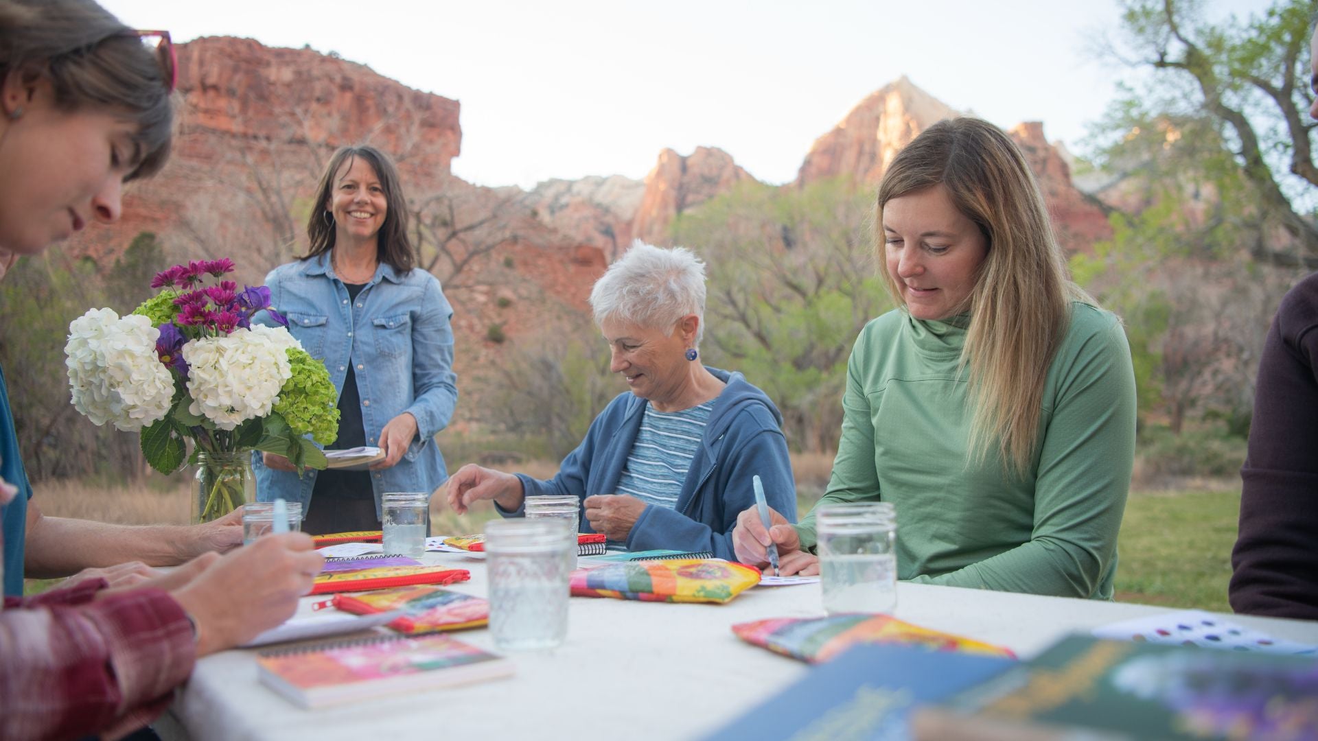 people sitting around a picnic table in Zion National Park watercolor painting